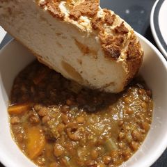 A picture of Lentil stew with crusty bread.
