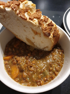 A picture of Lentil stew with crusty bread.