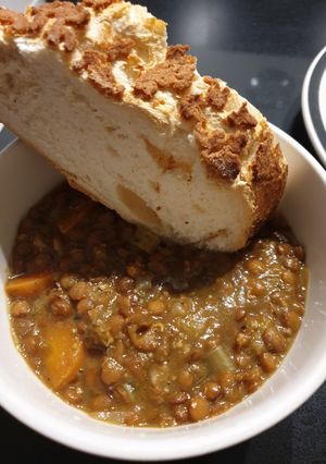 A picture of Lentil stew with crusty bread.