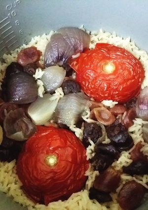 A picture of Tomato rice with Chinese sausage.