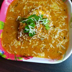 A picture of Stuffed cheese slice with paneer in gravy.
