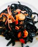 Homemade fresh squid ink pasta with prawns and squid