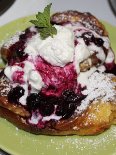 A picture of Stuffed Brioche French Toast with Blueberry Compote & Whipped Cream.