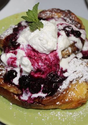A picture of Stuffed Brioche French Toast with Blueberry Compote & Whipped Cream.