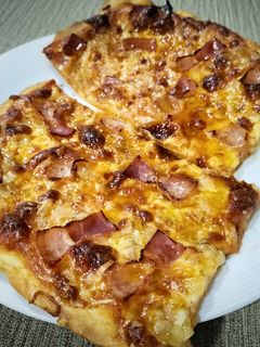 Una foto de Pizza con bacon y cebolla frita al orégano