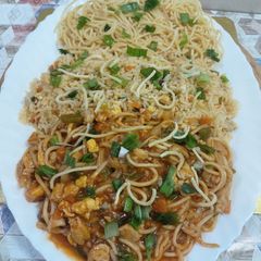 A picture of American chopsuey with fried rice.