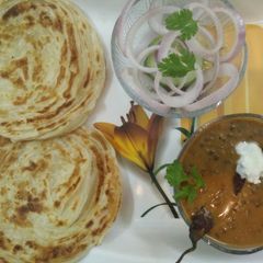 A picture of Lachha Paratha with Dal Makhani.