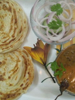 A picture of Lachha Paratha with Dal Makhani.