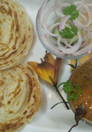 A picture of Lachha Paratha with Dal Makhani.