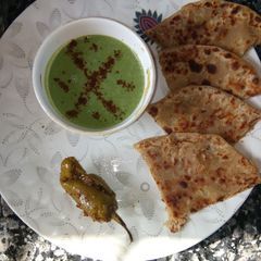 A picture of Aloo parantha with bathua raita.