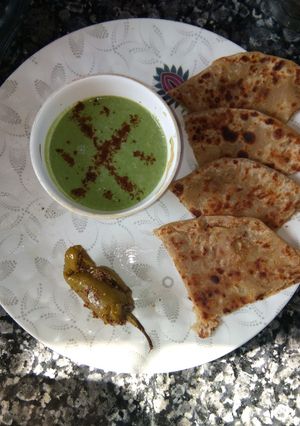 A picture of Aloo parantha with bathua raita.