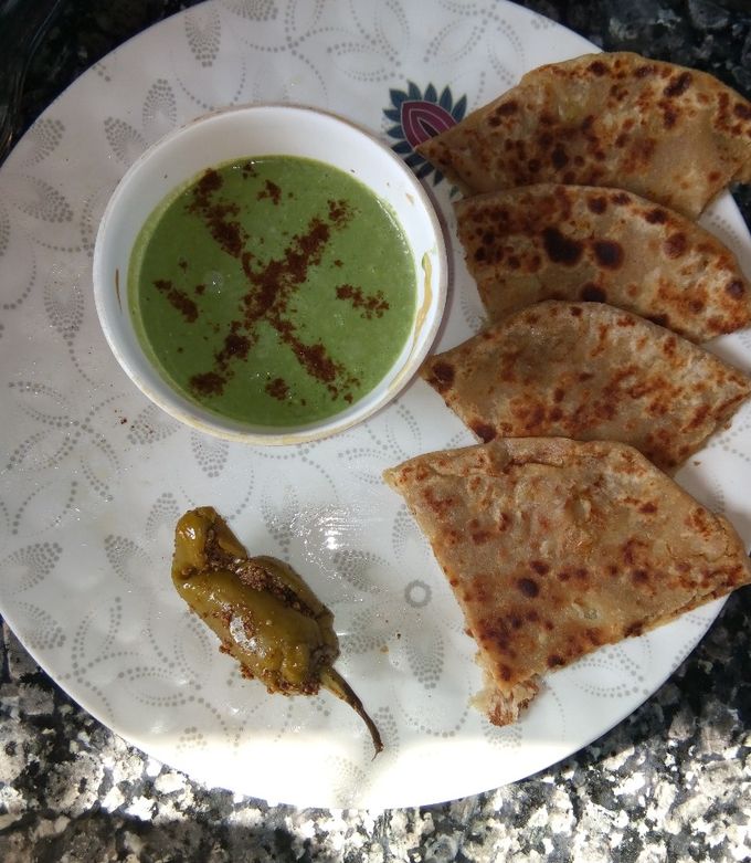 A picture of Aloo parantha with bathua raita.