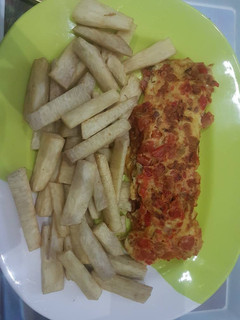 A picture of Fried egg with minced meat and fried yam.