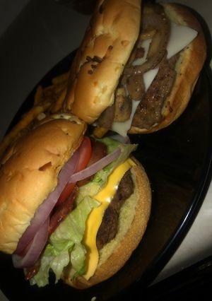 A picture of French onion burgers (mushroom & Swiss or fully loaded bacon burgers).