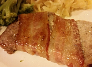 A picture of Brown sugar bacon wrapped pork chops.