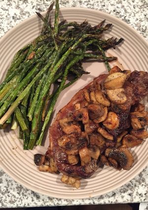 A picture of NY Strip Steak, Asparagus And Mushrooms.