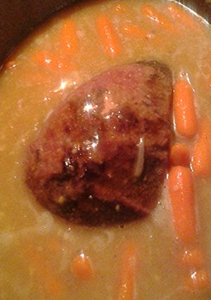 A picture of Beef roast and carrots.