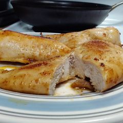 A picture of Seasoned, buttered boneless skinless chicken breast..