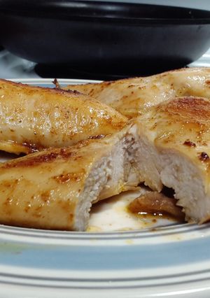 A picture of Seasoned, buttered boneless skinless chicken breast..