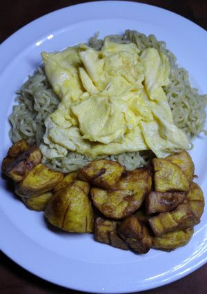 A picture of Buttered noodles with fluffy scrambled eggs & plantain.