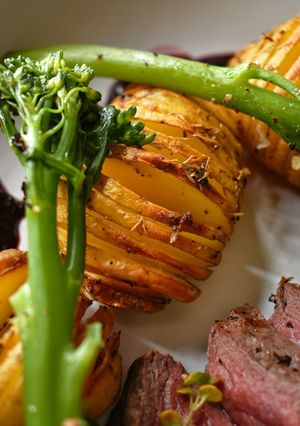 A picture of Hassleback New Potatoes With Garlic Butter & Thyme.