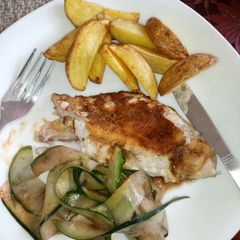 A picture of Deep fried potato wedges with pan fried red snapper and cucumber in balsamic vinegar.