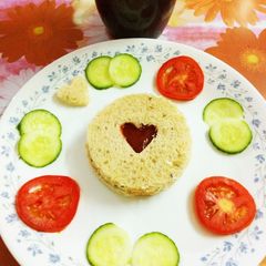 A picture of Whole grain bread with tomato ketchup and tomato,cucumber slices.