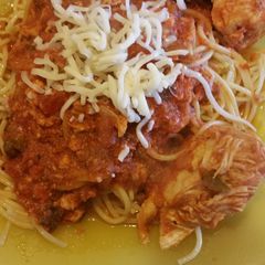 A picture of Saucy mexi chicken over noodles.