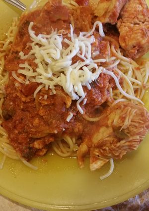 A picture of Saucy mexi chicken over noodles.