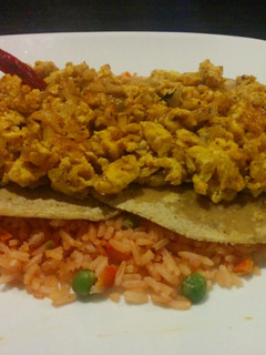 A picture of Scrambled rancheros' eggs over rice.