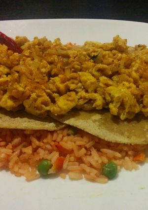A picture of Scrambled rancheros' eggs over rice.