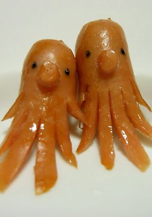 A picture of Character Bento : 2 Octopus with 1 Sausage.