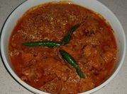 A picture of tomato chicken achari