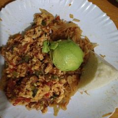 A picture of Scrambled eggs served with cabbage and ugali.