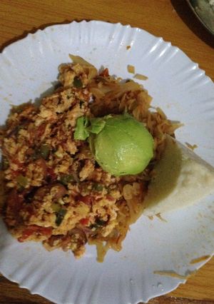 A picture of Scrambled eggs served with cabbage and ugali.