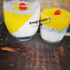 A picture of Pannacotta with mango sauce and basil seeds.