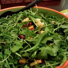 Arugula salad with candied almonds,walnuts,dates and apple A picture of Arugula salad with candied almonds,walnuts,dates and apple.