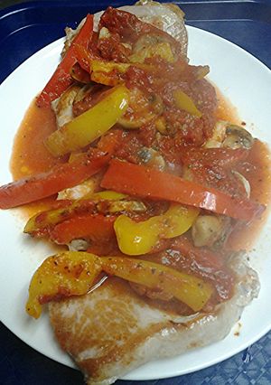 A picture of Pan seared pork loin with pizzaiola sauce.