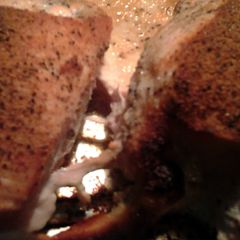 A picture of baked chicken with rub.