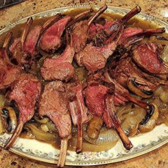 A picture of Rack of Lamb On Onions & Mushrooms with White Wine & Lamb Stock Sauce.
