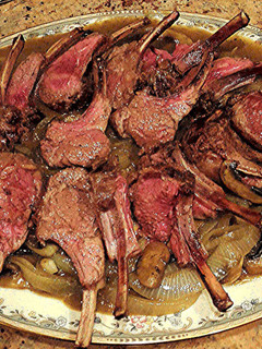 A picture of Rack of Lamb On Onions & Mushrooms with White Wine & Lamb Stock Sauce.