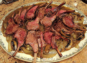 A picture of Rack of Lamb On Onions & Mushrooms with White Wine & Lamb Stock Sauce.