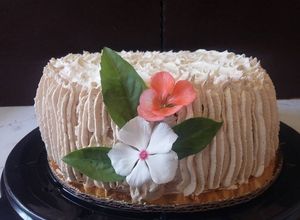Una foto de Pastel de café húmedo, con relleno de queso crema y betún de café