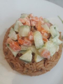 A picture of Jollof rice and coleslaw.