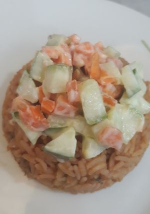 A picture of Jollof rice and coleslaw.