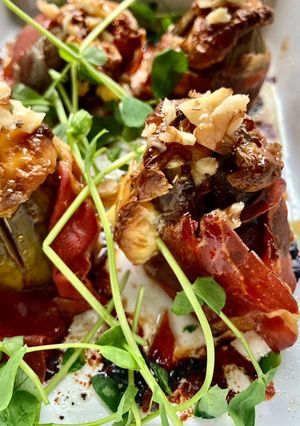 A picture of Baked figs, mascarpone and Parma Ham.