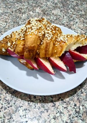 A picture of Croissant Sandwich with Fruit.