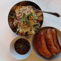 A picture of Potatoes salad with chorizo sausages and bean paste dressing.