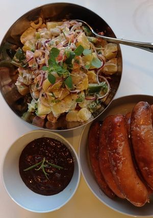 A picture of Potatoes salad with chorizo sausages and bean paste dressing.