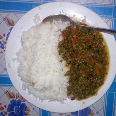 A picture of Boiled rice and green grams stew.